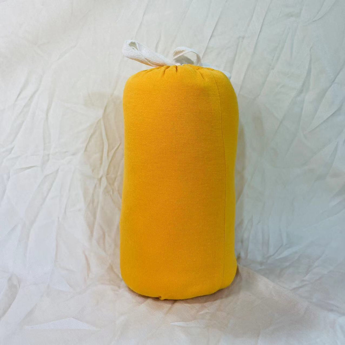 Baby wrap carrier in Yellow, rolled up for storage