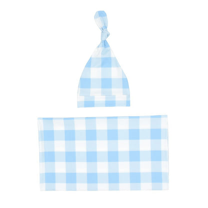 Light blue gingham swaddle blanket and knotted baby hat laid flat