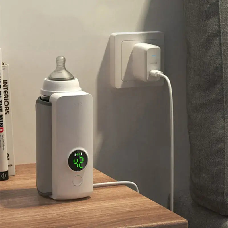 Two views of the rechargeable bottle warmer fitted to a baby bottle, with the portable base